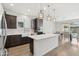 Open-concept kitchen and dining area with stainless appliances, modern lighting, and wood-look flooring at 22023 N 28Th Pl, Phoenix, AZ 85050