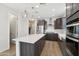 Spacious kitchen features an island, stainless steel appliances and dark brown cabinets at 22023 N 28Th Pl, Phoenix, AZ 85050