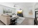 Open living area with a modern ceiling fan, tv, and comfortable sectional, perfect for relaxing at 22023 N 28Th Pl, Phoenix, AZ 85050