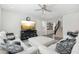 Comfortable living area featuring a ceiling fan, television, and staircase leading to the second floor at 22023 N 28Th Pl, Phoenix, AZ 85050
