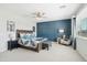 Spacious main bedroom with a decorative blue accent wall, ceiling fan, and a large window for natural light at 22023 N 28Th Pl, Phoenix, AZ 85050