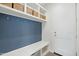 Mudroom area features a bench, hooks, and open shelving with wicker baskets for storage at 22023 N 28Th Pl, Phoenix, AZ 85050