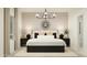 Serene main bedroom featuring neutral décor, a large window, and stylish lighting fixtures at 23207 W Marguerite Ave, Buckeye, AZ 85326