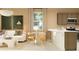 Open-concept living room and kitchen with modern decor, light-colored walls, and dining nook at 23372 W Sonrisas St, Buckeye, AZ 85326