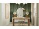 Home office with desk, chair, a stylish mirror, lamps, and chic wallpaper at 23372 W Sonrisas St, Buckeye, AZ 85326