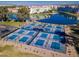 An aerial view of multiple pickleball courts beside a lake, featuring the community's focus on active living at 2511 W Queen Creek Rd # 374, Chandler, AZ 85248