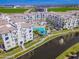 Elevated view of a community featuring a waterway, pool and white buildings with blue awnings at 2511 W Queen Creek Rd # 374, Chandler, AZ 85248