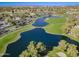 A scenic aerial view of the golf course with a lake and luxury homes in the DC Ranch community at 2511 W Queen Creek Rd # 374, Chandler, AZ 85248