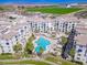 Aerial view of a community pool, landscaping, and apartment buildings, showcasing the layout at 2511 W Queen Creek Rd # 374, Chandler, AZ 85248