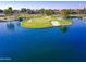 A stunning aerial view of the golf course with water feature and green, showcasing the beauty of the community at 2511 W Queen Creek Rd # 374, Chandler, AZ 85248