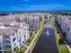 Stunning aerial view of waterfront condos with fountains, lush landscaping, and mountain views at 2511 W Queen Creek Rd # 374, Chandler, AZ 85248