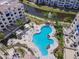 Aerial view of the community pool, clubhouse, and manicured landscape next to the waterway at 2511 W Queen Creek Rd # 374, Chandler, AZ 85248