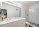 Bright bathroom with double sink vanity, quartz countertops, and glass enclosed shower with herringbone tile at 2511 W Queen Creek Rd # 374, Chandler, AZ 85248