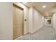 Hallway with carpeting and a doorway marked #374 with an exit sign ahead at 2511 W Queen Creek Rd # 374, Chandler, AZ 85248