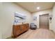 Hallway with a wooden accent table, modern art, and an elevator at 2511 W Queen Creek Rd # 374, Chandler, AZ 85248