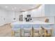 Modern kitchen boasts white cabinets, stainless steel appliances, an island, and stylish bar stool seating at 2511 W Queen Creek Rd # 374, Chandler, AZ 85248