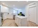 Open concept living area with light wood flooring, a modern kitchen with white cabinets and stainless steel appliances at 2511 W Queen Creek Rd # 374, Chandler, AZ 85248
