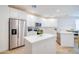 Bright kitchen with white cabinets, stainless steel appliances, quartz countertops, and island at 2511 W Queen Creek Rd # 374, Chandler, AZ 85248