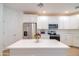 Bright kitchen with white cabinets, stainless steel appliances, quartz countertops, and island at 2511 W Queen Creek Rd # 374, Chandler, AZ 85248