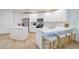 Modern kitchen boasts white cabinets, stainless steel appliances, an island, and stylish bar stool seating at 2511 W Queen Creek Rd # 374, Chandler, AZ 85248
