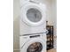 Efficient laundry area with a stacked washer and dryer unit, maximizing space in the home at 2511 W Queen Creek Rd # 374, Chandler, AZ 85248