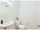 Bright powder room features a round mirror, pedestal sink, and modern fixtures for guests at 2511 W Queen Creek Rd # 374, Chandler, AZ 85248
