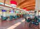 A cozy restaurant interior with a wooden ceiling, multiple TVs, and comfortable seating at the bar and tables at 2511 W Queen Creek Rd # 374, Chandler, AZ 85248