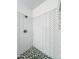 Shower featuring eye-catching herringbone patterned tilework and a mosaic tiled floor at 2511 W Queen Creek Rd # 374, Chandler, AZ 85248