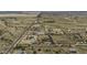 Expansive aerial shot of a desert property featuring multiple structures and wide open spaces at 2751 N Ralston Rd, Maricopa, AZ 85139