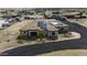 Aerial view of a single-story home with a circular drive, solar panels and RV parking area at 2751 N Ralston Rd, Maricopa, AZ 85139