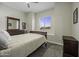 Well-lit bedroom featuring a large window and dresser set at 2751 N Ralston Rd, Maricopa, AZ 85139