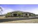 Single story home with desert landscaping, gravel drive, tile roof, solar panels and covered front porch at 2751 N Ralston Rd, Maricopa, AZ 85139