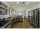 Spacious kitchen featuring wood floors, stainless steel appliances, and plenty of natural light at 2751 N Ralston Rd, Maricopa, AZ 85139