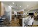 Open kitchen and living area with hardwood floors, stainless steel appliances and bar seating at 2751 N Ralston Rd, Maricopa, AZ 85139