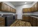 Functional laundry room with wooden cabinets for ample storage space at 2751 N Ralston Rd, Maricopa, AZ 85139