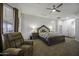 Main bedroom featuring a ceiling fan, an ensuite bathroom and natural light at 2751 N Ralston Rd, Maricopa, AZ 85139