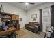 Office with a built-in desk and a cozy brown sofa to sit and relax at 2751 N Ralston Rd, Maricopa, AZ 85139