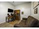 Office space with wooden desk, sofa, and built-in shelves for storage at 2751 N Ralston Rd, Maricopa, AZ 85139