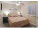 Cozy bedroom with neutral tones, and a window with plantation shutters at 2917 E Northridge St, Mesa, AZ 85213