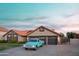 Charming single-story home with a blue truck, lush plants and an attached two-car garage at 2917 E Northridge St, Mesa, AZ 85213