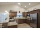 Spacious kitchen featuring granite countertops, stainless steel appliances, and tile flooring at 2917 E Northridge St, Mesa, AZ 85213