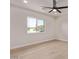 Sunny bedroom with wood floors and a large window showcasing the neighborhood at 2926 E Corrine Dr, Phoenix, AZ 85032