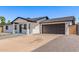 Newly renovated home featuring clean modern lines, fresh exterior paint, and a spacious driveway at 2926 E Corrine Dr, Phoenix, AZ 85032