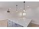 Spacious kitchen with island and seating features new stainless appliances, modern lighting, and an open floorplan at 2926 E Corrine Dr, Phoenix, AZ 85032