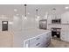 Newly remodeled kitchen features a large island, quartz countertops, stainless steel appliances, and modern lighting at 2926 E Corrine Dr, Phoenix, AZ 85032