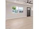 Open living space featuring light wood floors, neutral walls, and ample natural light at 2926 E Corrine Dr, Phoenix, AZ 85032