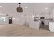 Open floor plan in living room with wood floors and views of the kitchen at 2926 E Corrine Dr, Phoenix, AZ 85032