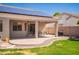 Backyard with covered patio, solar panels, and landscaped yard at 2945 E Clifton Ave, Gilbert, AZ 85295
