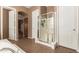 Bathroom featuring a glass shower, white doors, an arched hallway entrance, and tile flooring at 2945 E Clifton Ave, Gilbert, AZ 85295