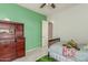 Bedroom features light green and white walls, wooden furniture, and a bed at 2945 E Clifton Ave, Gilbert, AZ 85295